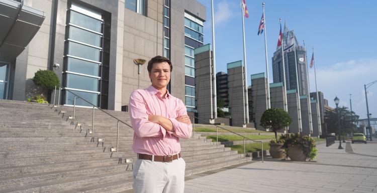 Gabriel Kucala standing in downtown Mobile. 